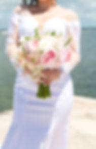 Bride holding pink and white floral bouquet