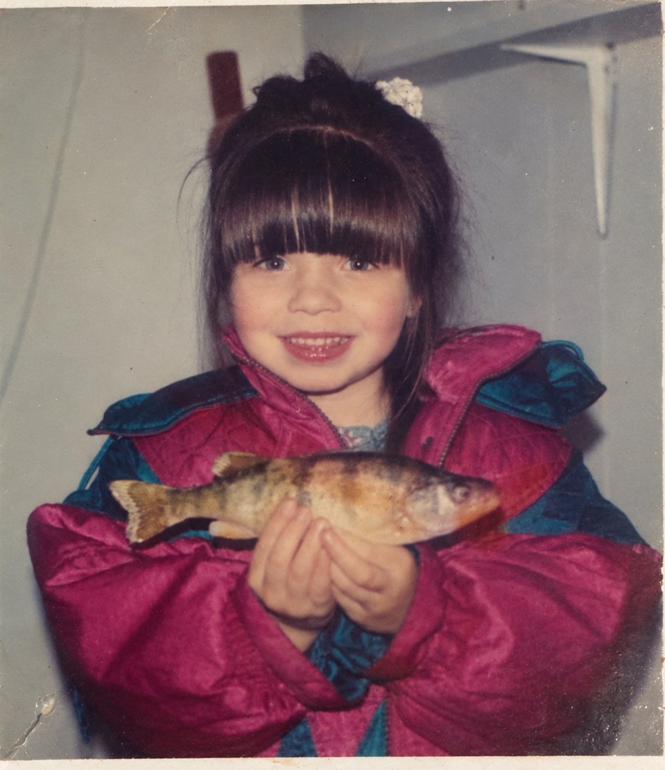 Autumn Cardillo as a girl holding a fish