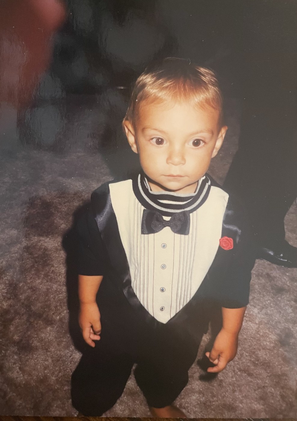 Anthony Cardillo as a toddler in a tuxedo bib
