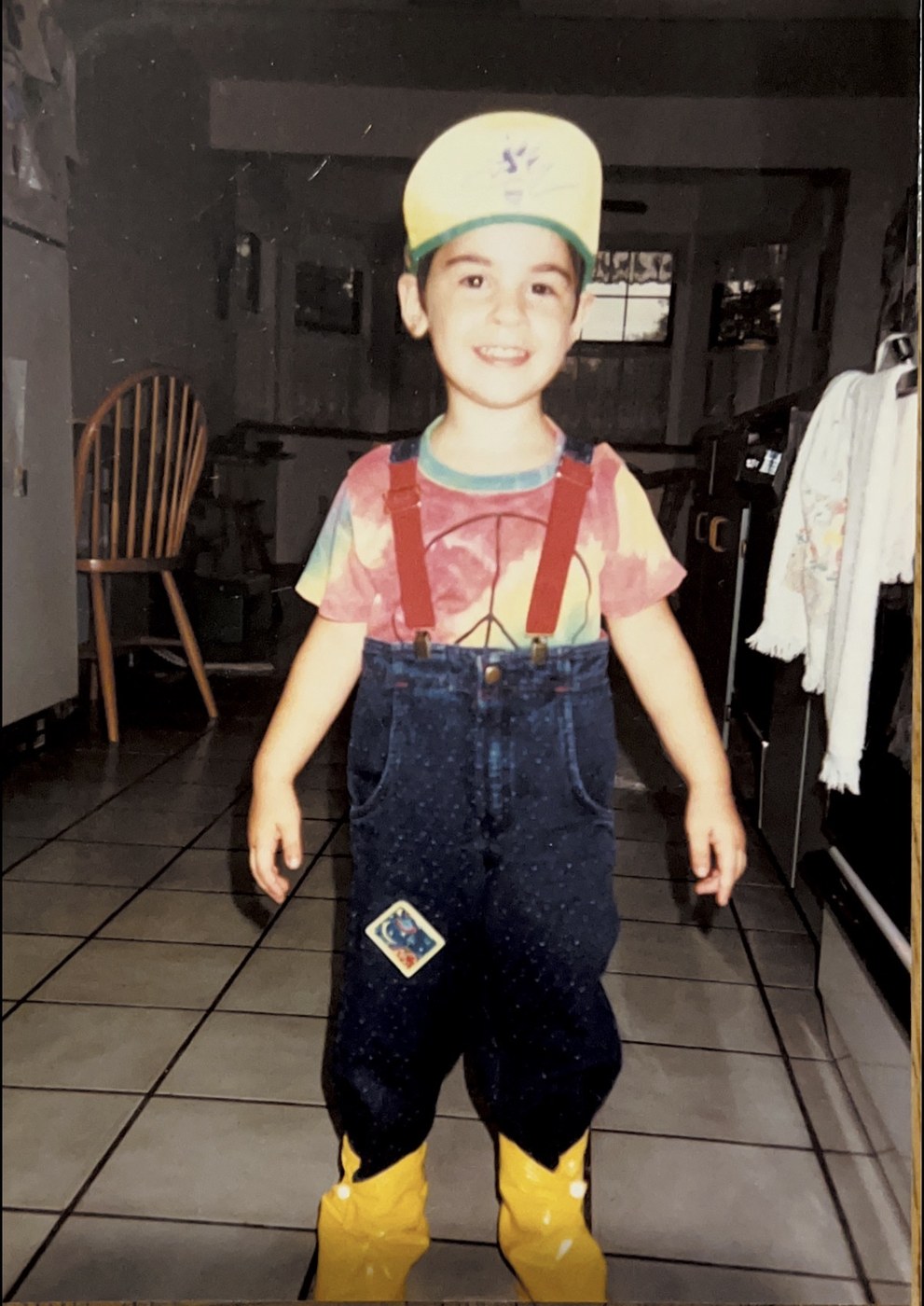 Dr. Stramiello as a child in a yellow cap and red suspenders