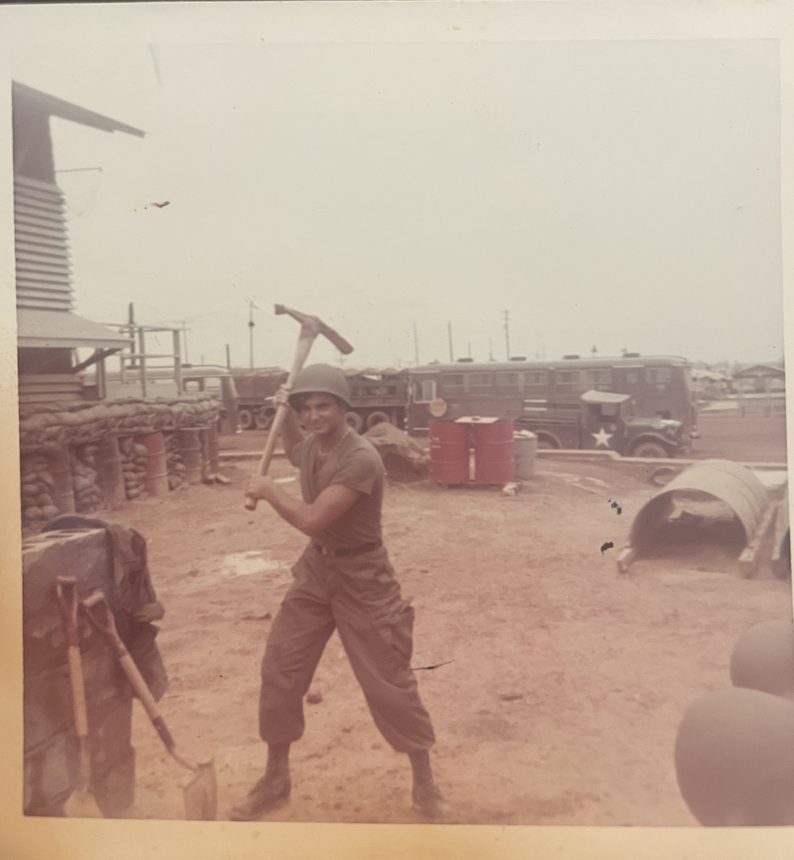 A man holding a pickaxe at a work site