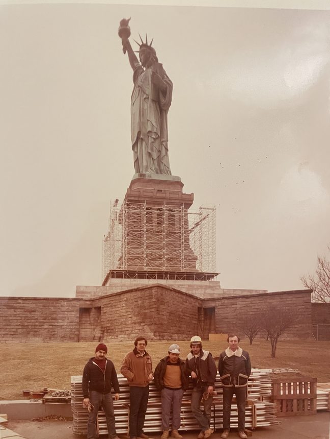 Workmen on scaffolding at the Statue of Liberty during repairs