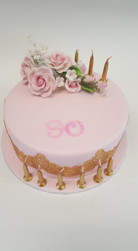 Pretty pink fruit cake, adorned with sugar flowers and gold lace. Made for a lady born same day as Queen Elixabeth II