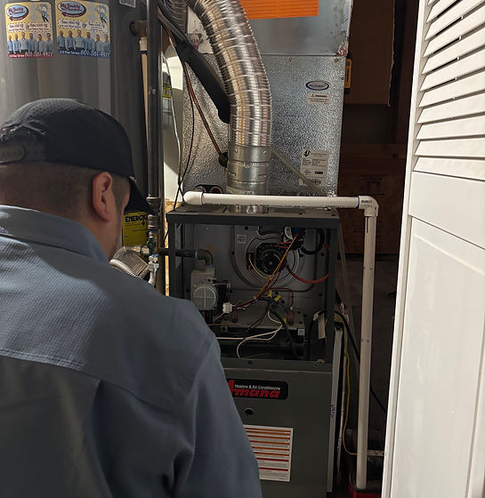 Technician inspecting a furnace.