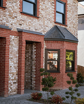 Victorian-era home in Upminster with a red brick facade, a gabled roof, and white sash windows.