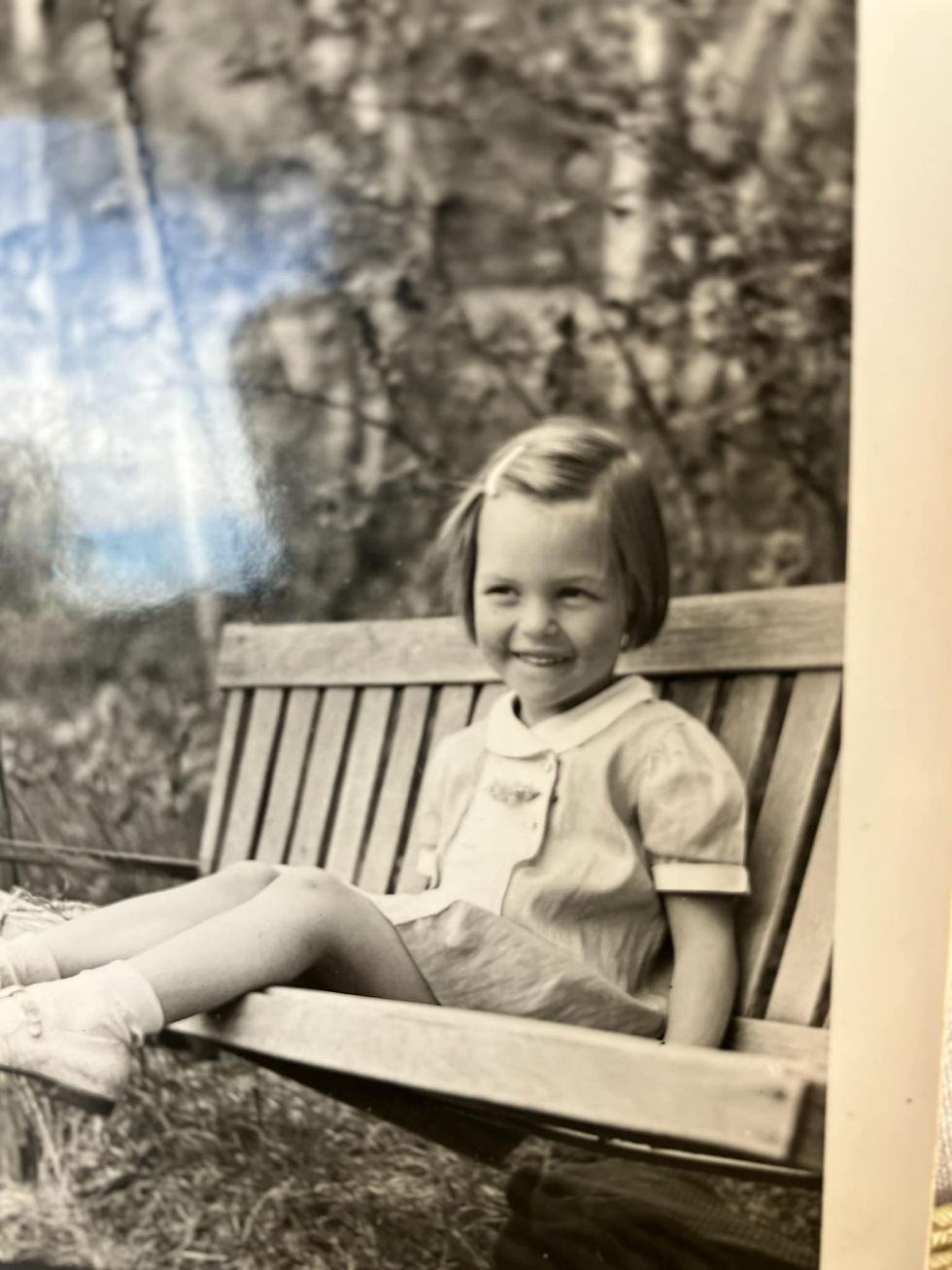 little girl on a porch swing