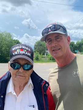 Two veterans, one wearing a World War II Veteran hat