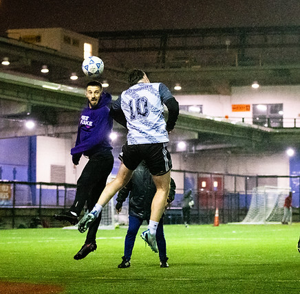 Soccer players in action under the night lights