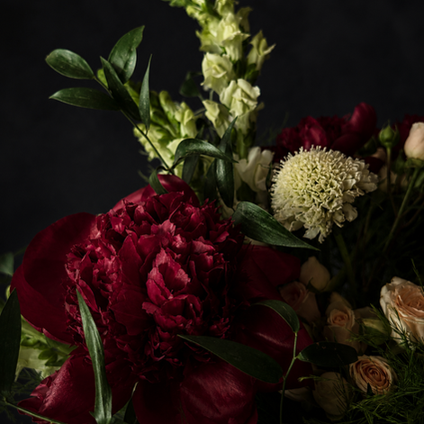 Luxury burgundy peony arrangement with blush roses, white scabiosa, and cascading amaranthus in a stone urn — The Crimson Ban