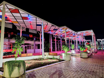 Illuminated, designed sheds next to a commercial center, constructed by the company "Ami & Igal"