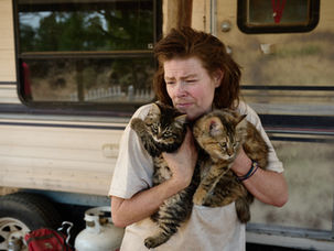 Christine Greene holds her cats, Skye and Zippy, outside the trailer where she and her partner live east of Bend. Greene has been homeless since 2016, living on the streets, in shelters, and near China Hat Road. She has also struggled with health issues and substance abuse. Photo by Joe Kline.