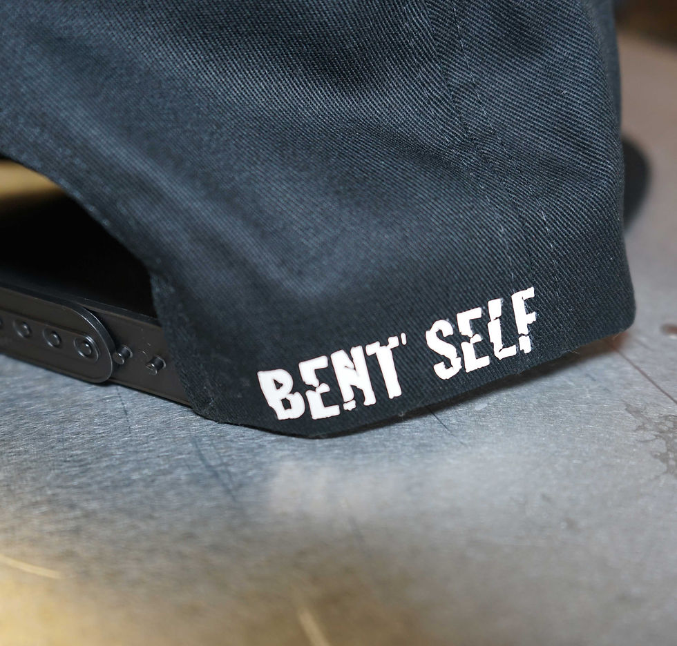 Thumbnail: Bent Self symbol logo in white (glow in dark) on black snap back hat.