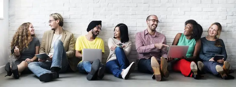 seven diverse people seated in a hallway waiting for class