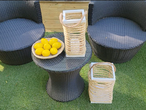 Outdoor deck with chairs, rug, and decorative lanterns and bowl