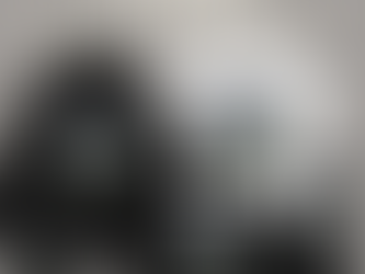 A promotional display titled “Ranger Resilience Kit” shows a coordinated set of black and white gear featuring the circular “Amethyst Sanctum” emblem—an illustration of a purple crystalline building set against rolling green hills and a blue sky. The collection includes a black hoodie, white T-shirt, black beanie, duffel bag, tumbler, and baseball cap, all neatly arranged on a neutral gray background with the title in bold lettering above.