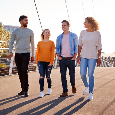 group-of-young-friends-walking-across-city-bridge-2026-03-10-04-02-11-utc.jpg