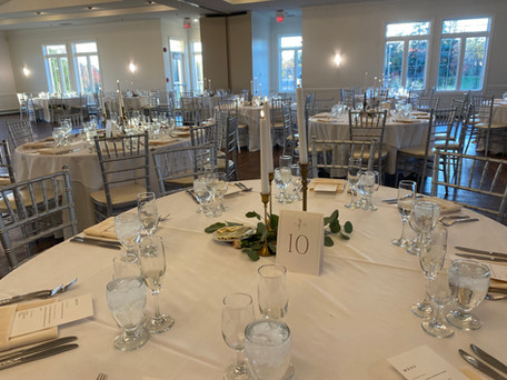 Taper candle centerpieces set in Ruffled Feathers Golf Club reception space 