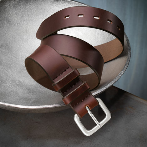 Brown leather belt photographed in a studio setting
