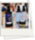Image of Cosmic Tula products at an exhibtion in a polaroid frame. Including the Euphoric, Shift, Expanse Mood sprays and the Cosre and Sense Chakra Balms.