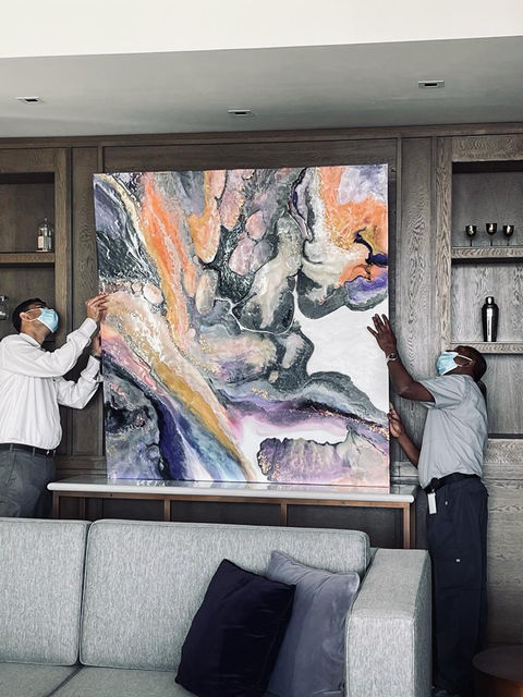 A photo of the installation of the resin panel designed and created by SANTI Design House. The panel was created for the JW Marriott hotel.