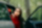 motion sickness of a woman in a car door opened ready to vomit