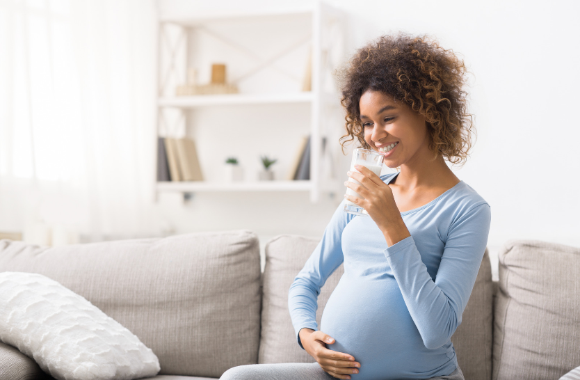 pregnant woman drinking natural milk to help with lactation