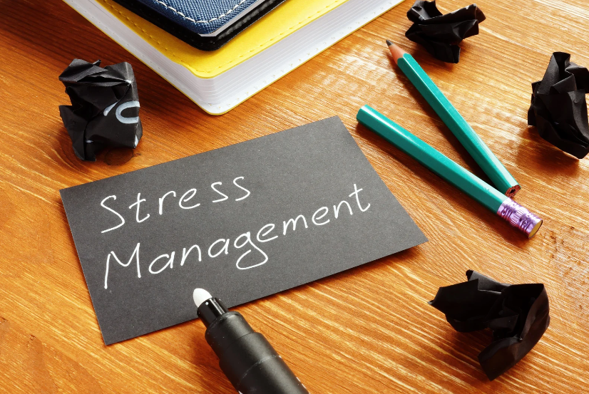stress management card on an office desk with pencils and crumpled paper