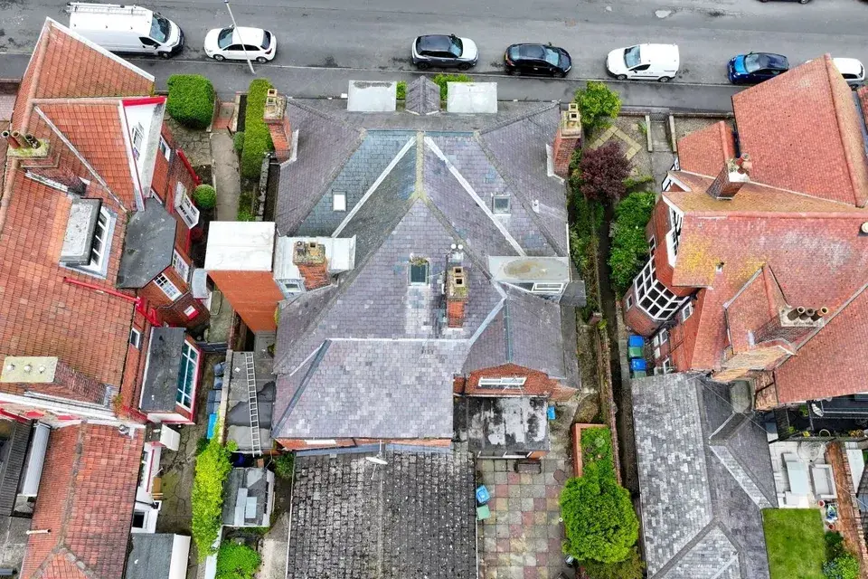 Drone shot from above the rooftops of some detached houses