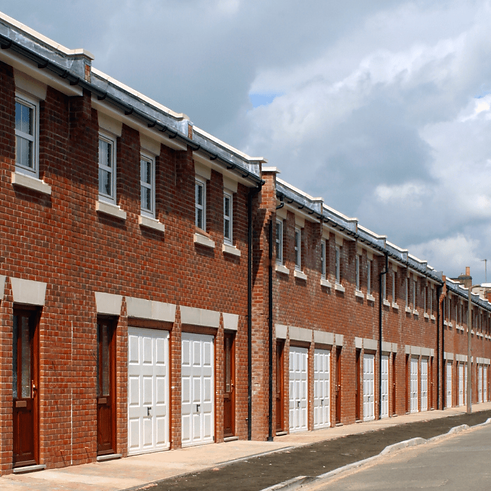 A row of identical, small terraced houses which have been recently built