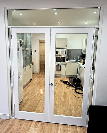 Custom fitted white doors with clear glass panels to divide up a room