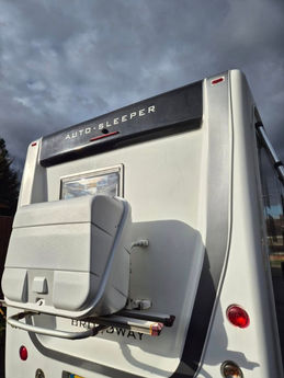 The back of a very clean White motorhome.