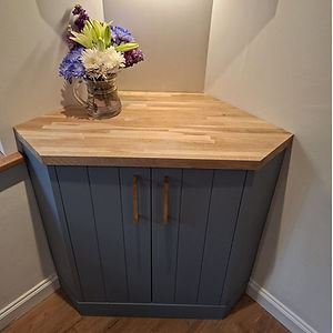 Grey unit with gold handles fitted into an alcove