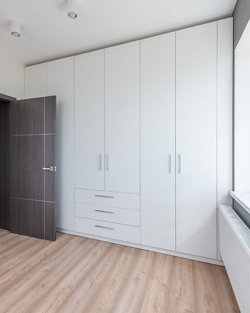 Made to measure floor to ceiling whitewardrobes with long silver handles