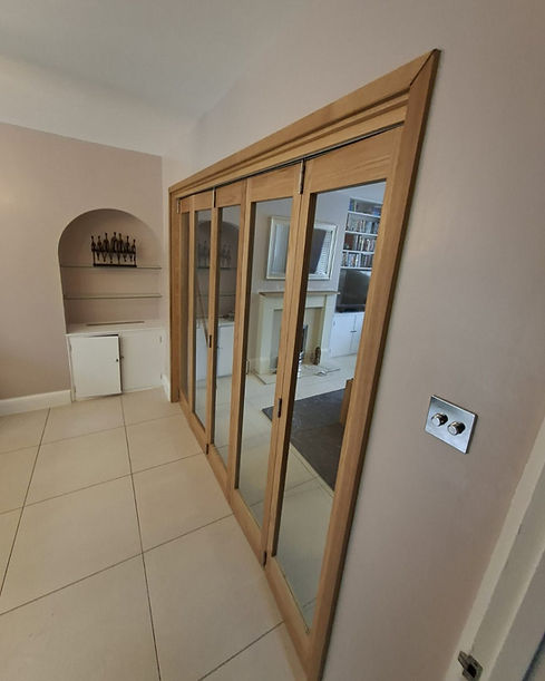 bespoke oak framed bifold door, installed to divide a room