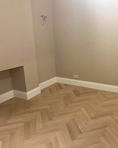 Perfectly fitted white skirting board against a putty coloured wall