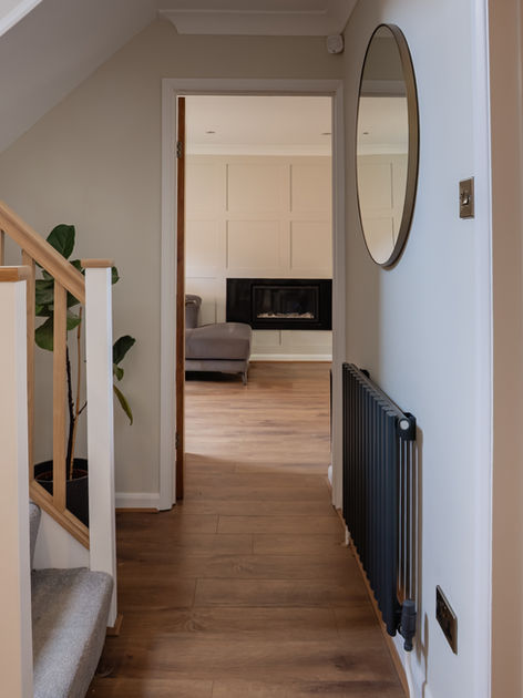 Hallway with wooden flooring, mirror and nature inspired styling