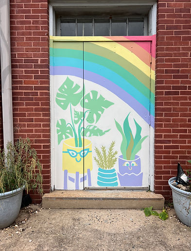 colorful outdoor mural painting of personified plants under a rainbow