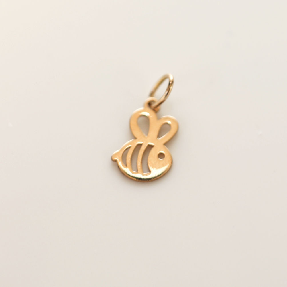 Custom 18K gold jewelry by Glowd Studio featuring fine details like diamonds, yellow sapphire, pearls, agate, jade, turquoise