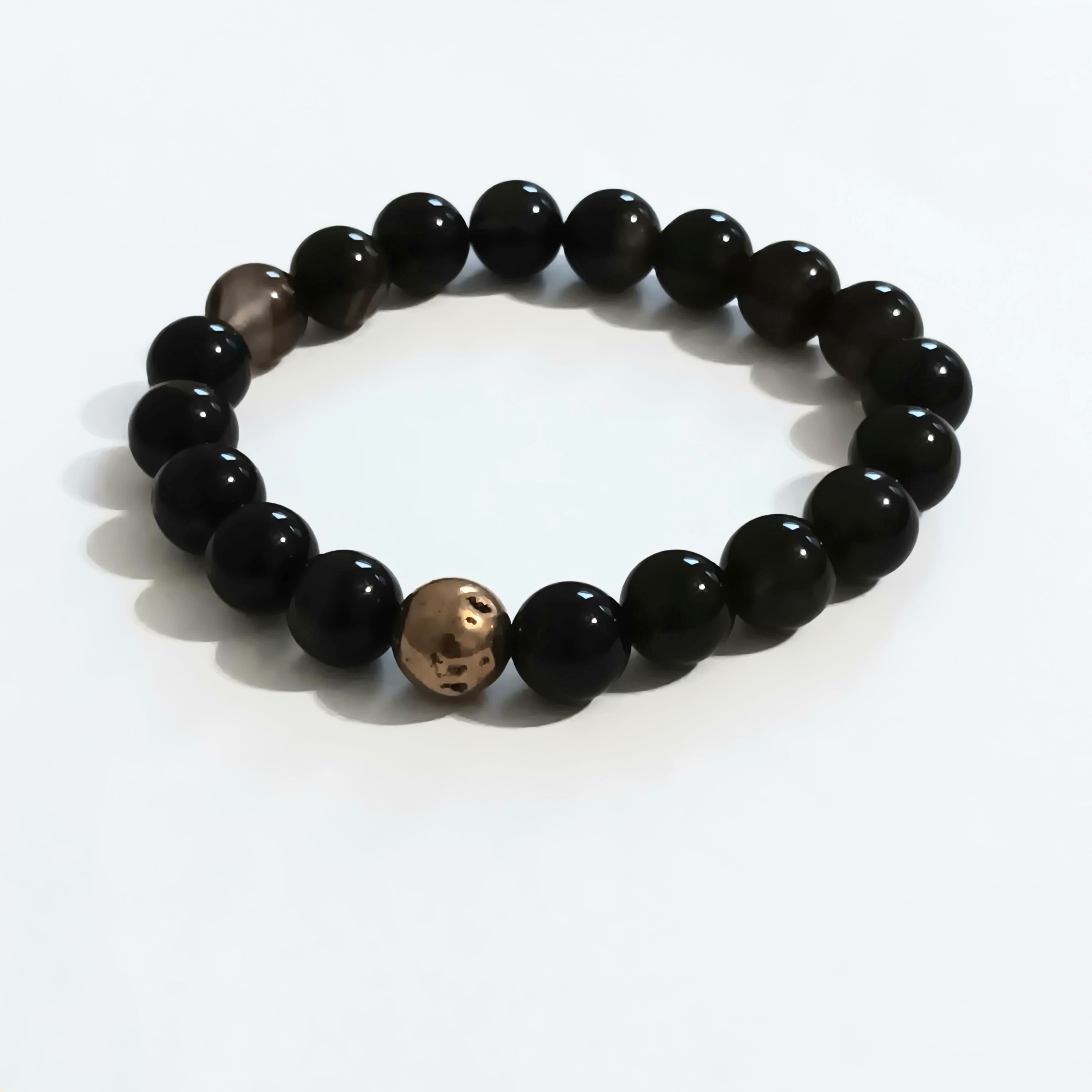 Stretch bracelet coffee brown 10mm round beads with a gold stone bead in the center