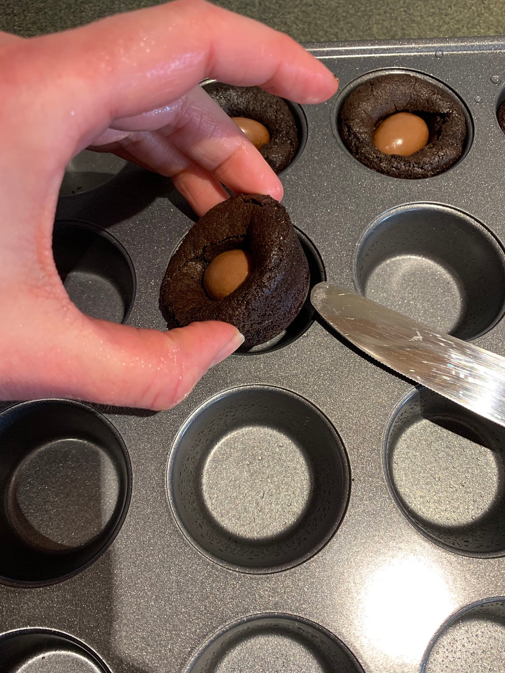 Costco Milk Chocolate Covered Almond Brownie Cookie. Carefully removing with butterknife.