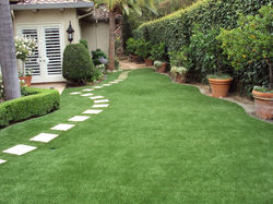 artificial-grass-lawn-a-11259-1-easyturf-back-yard-after-synthetic-turf-installation-with_grass-in-t