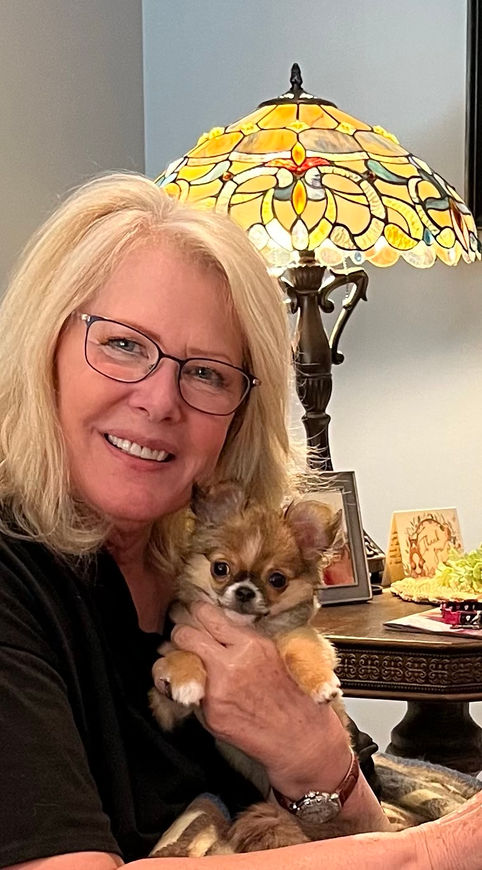 A Woman Holding a tan Dog