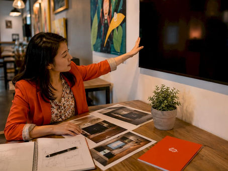 Woman arranging digital signage displays at desk