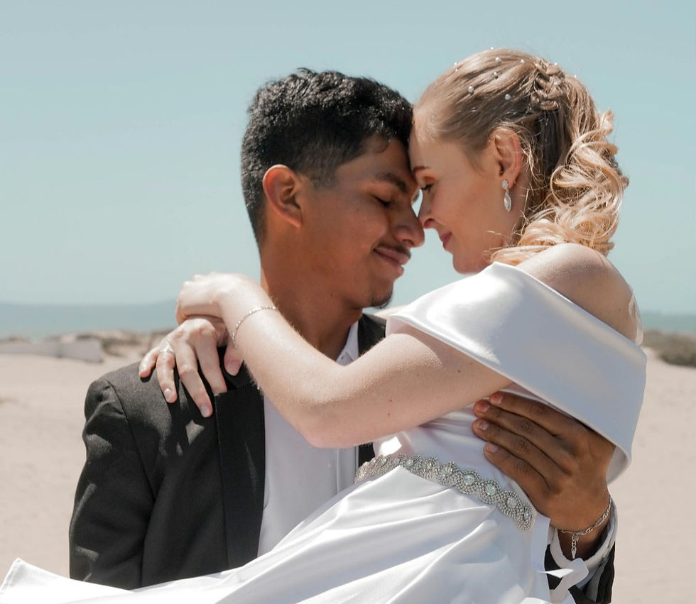 Sami and I, a couple on our wedding day. Man lifting up woman