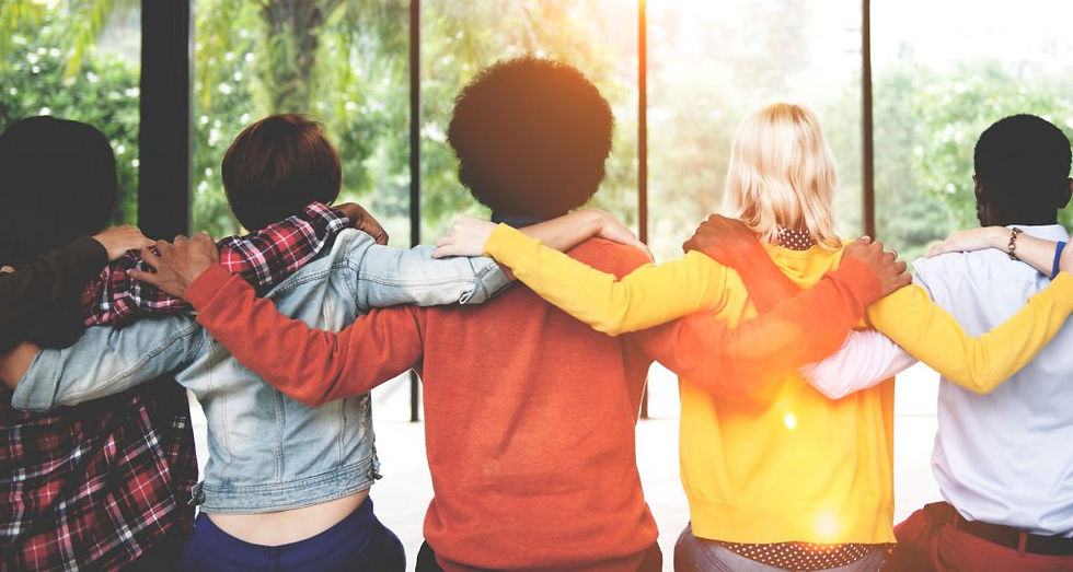 group of people holding round each other