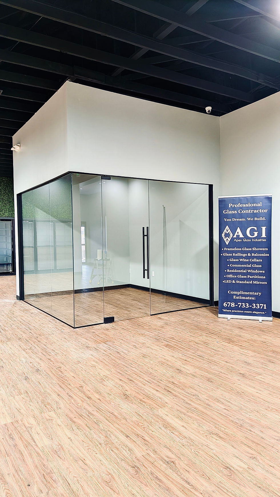 Completed commercial glass partition system designed to support product presentation and customer experience.