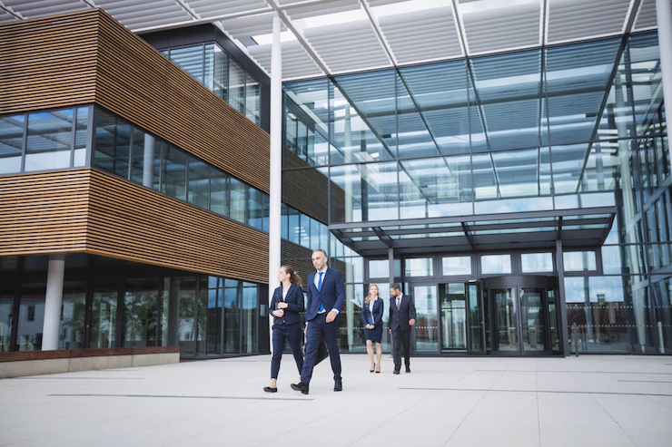 business-people-walking-outside-office-building_107420-74359.webp