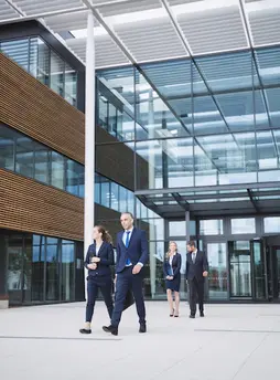 business-people-walking-outside-office-building_107420-74359.webp
