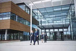 business-people-walking-outside-office-building_107420-74359.webp