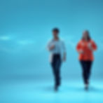 Dynamic shot of daily coordination in motion — two or three healthcare team members walkin